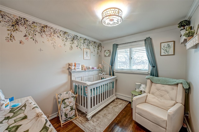 bedroom featuring a baseboard heating unit, crown molding, dark hardwood / wood-style floors, and a crib