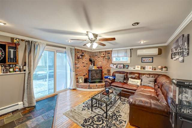 living room with ceiling fan, a wood stove, a baseboard radiator, crown molding, and an AC wall unit