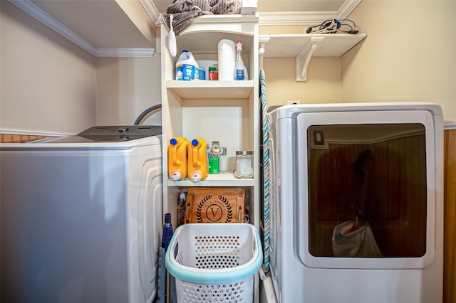 laundry room featuring crown molding and washing machine and clothes dryer