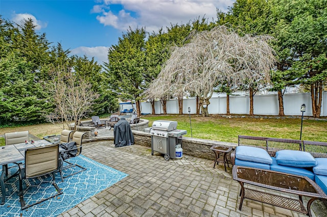 view of patio / terrace featuring a grill and an outdoor living space with a fire pit