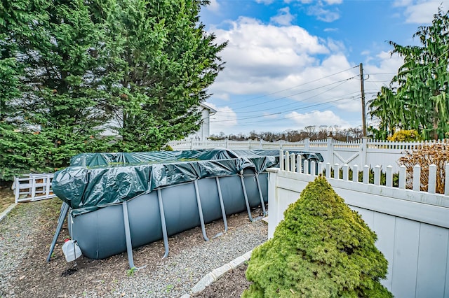 view of yard featuring a covered pool