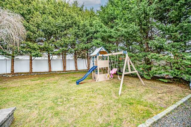 view of jungle gym featuring a lawn