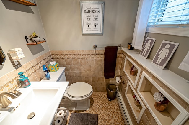 bathroom featuring toilet, tile walls, tile patterned flooring, a baseboard heating unit, and sink