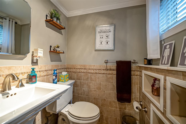 bathroom with sink, tile walls, toilet, and ornamental molding