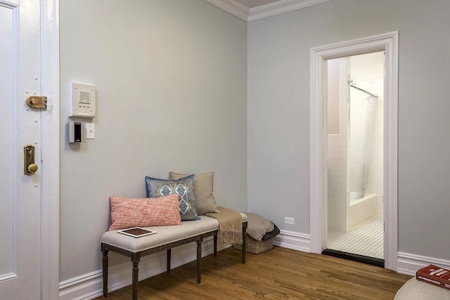 sitting room with hardwood / wood-style flooring and ornamental molding