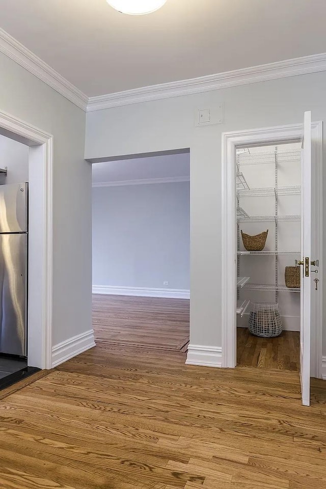 interior space with wood-type flooring and ornamental molding