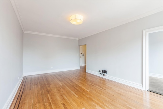 empty room featuring light hardwood / wood-style flooring and ornamental molding