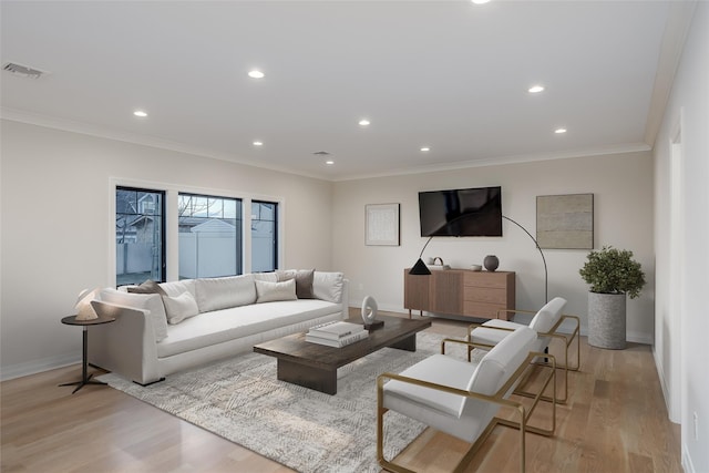 living room with light hardwood / wood-style floors and ornamental molding