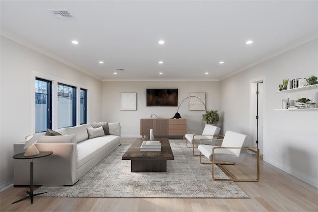 living room with light wood-type flooring and crown molding