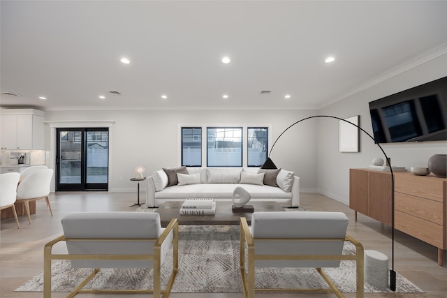 living room with crown molding and light hardwood / wood-style floors