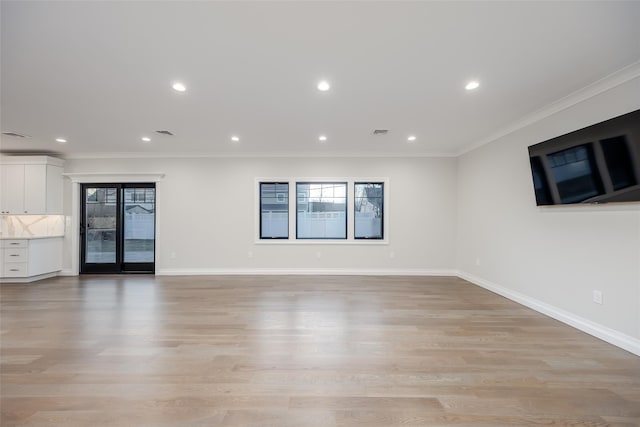 empty room featuring light hardwood / wood-style floors and ornamental molding