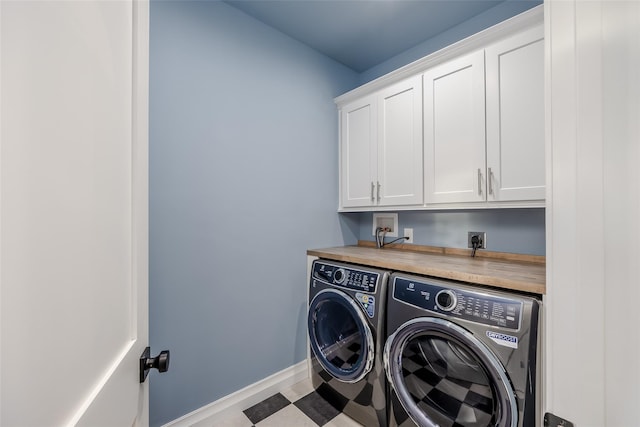 laundry room with cabinets and washer and clothes dryer