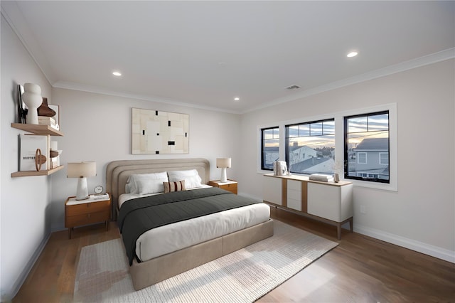 bedroom featuring crown molding and hardwood / wood-style flooring