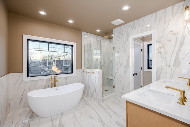 bathroom with vanity, tile walls, and separate shower and tub