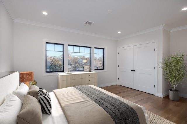 bedroom featuring ornamental molding and dark wood-type flooring