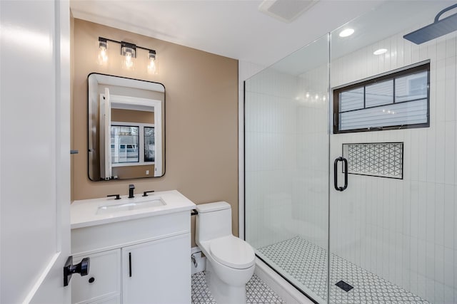 bathroom with vanity, toilet, walk in shower, and tile patterned flooring