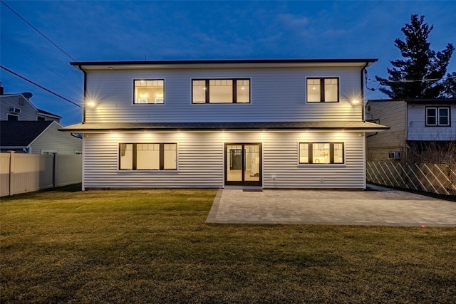 back of house featuring a patio and a lawn