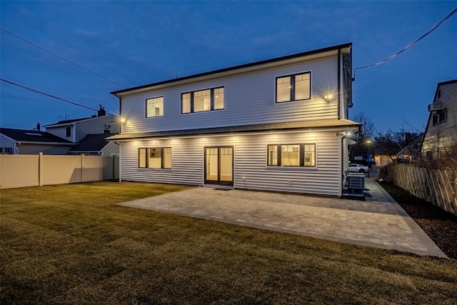 rear view of house with a yard and a patio