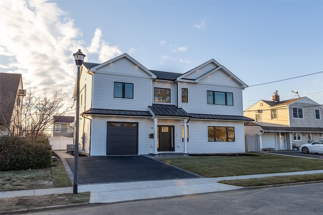 view of front of house featuring a garage and a front lawn