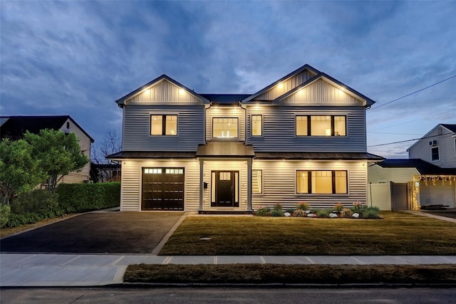 view of front of home featuring a garage and a front lawn