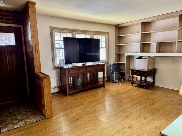 living room with light hardwood / wood-style flooring and a baseboard radiator