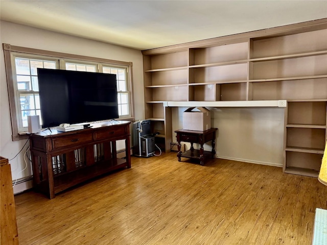 living room featuring wood-type flooring and a baseboard heating unit