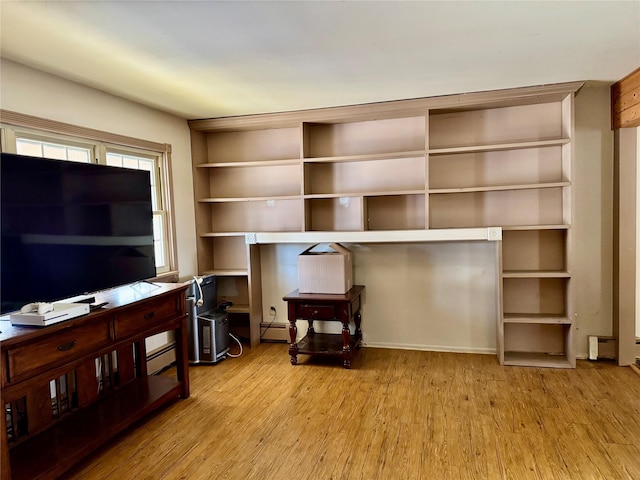 interior space featuring a baseboard heating unit and light hardwood / wood-style flooring