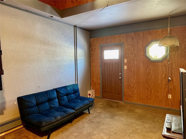 entryway featuring wooden walls, light carpet, and a baseboard heating unit