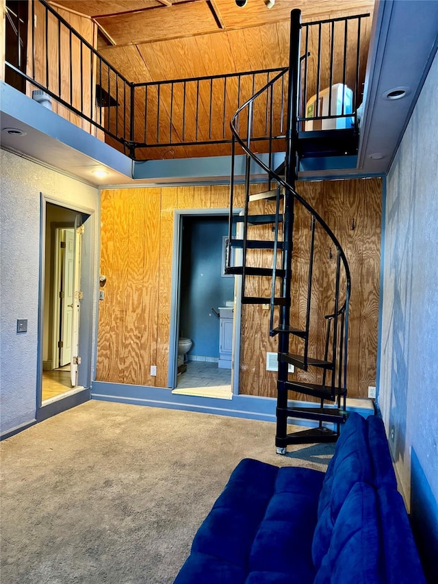 stairs featuring wood ceiling and carpet floors