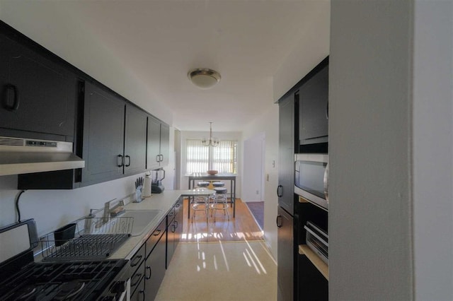 kitchen with sink, hanging light fixtures, an inviting chandelier, and appliances with stainless steel finishes