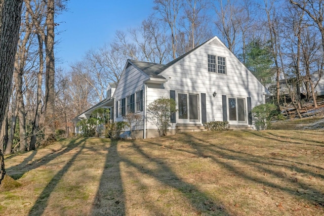 view of property exterior with a lawn