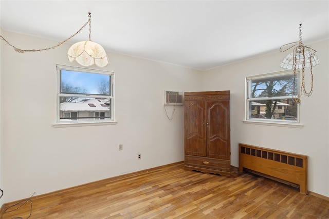 interior space featuring radiator heating unit and wood-type flooring