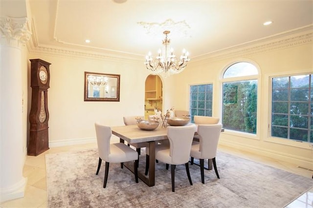 dining space featuring a chandelier, ornamental molding, and light tile patterned floors