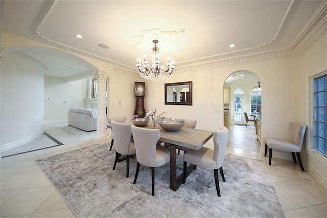 tiled dining area featuring an inviting chandelier