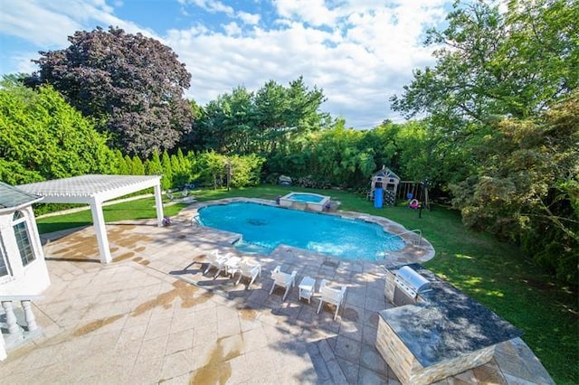 view of swimming pool featuring an in ground hot tub, a patio area, a lawn, and a playground