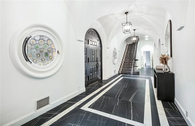 foyer entrance with an inviting chandelier