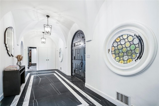 foyer featuring a chandelier