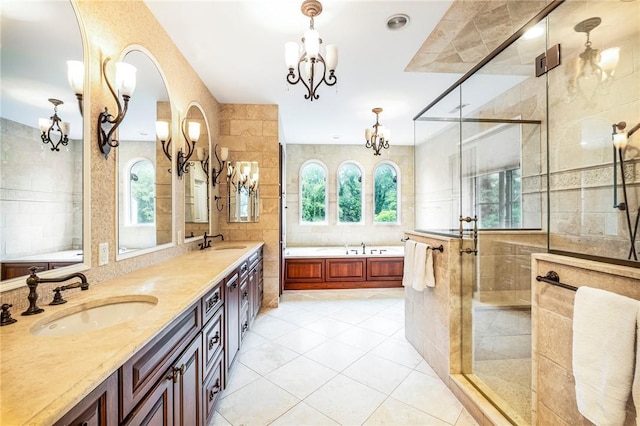 bathroom with tile patterned floors, an inviting chandelier, shower with separate bathtub, tile walls, and vanity