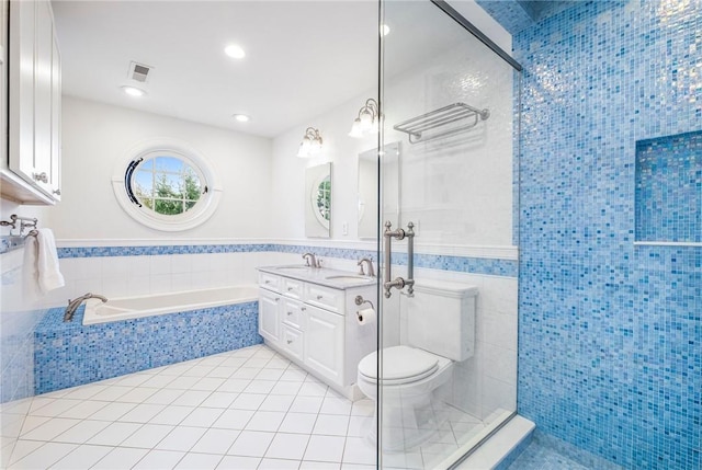 full bathroom with toilet, separate shower and tub, tile walls, vanity, and tile patterned flooring