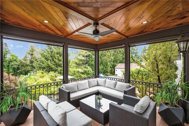 sunroom / solarium with wood ceiling, ceiling fan, and plenty of natural light