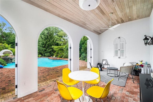 view of pool with ceiling fan and a patio area