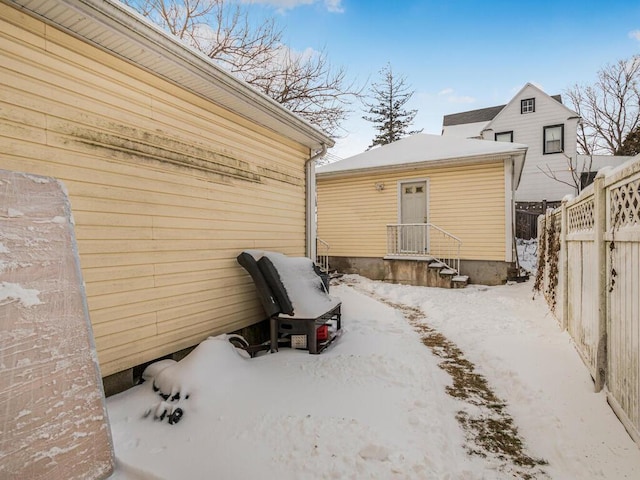 view of snow covered back of property