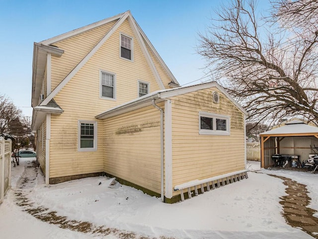 snow covered property featuring a gazebo