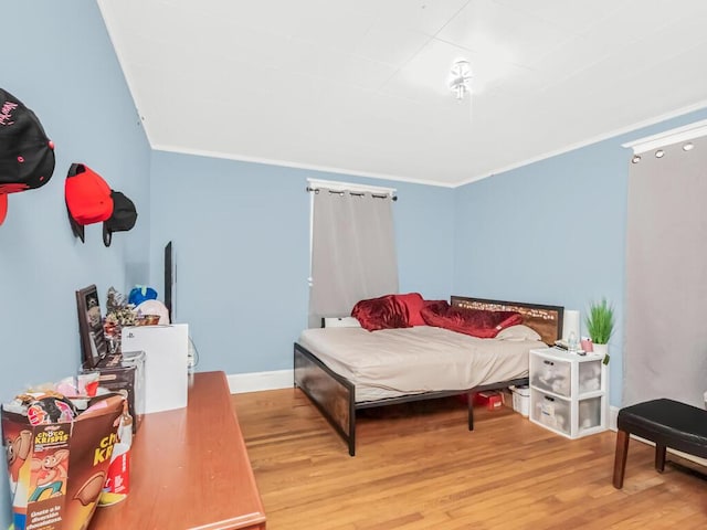 bedroom featuring light hardwood / wood-style floors and ornamental molding