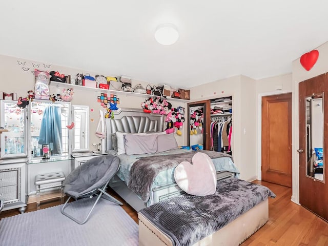 bedroom with a closet and light hardwood / wood-style flooring