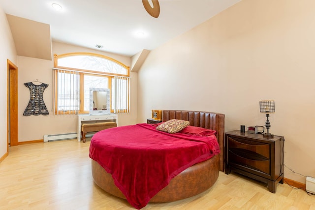 bedroom with baseboard heating and wood-type flooring