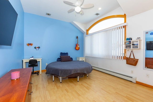 bedroom featuring baseboard heating, multiple windows, light hardwood / wood-style flooring, and ceiling fan