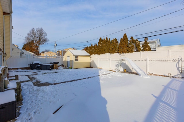 snowy yard with a storage unit