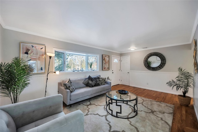 living room with wood-type flooring and crown molding