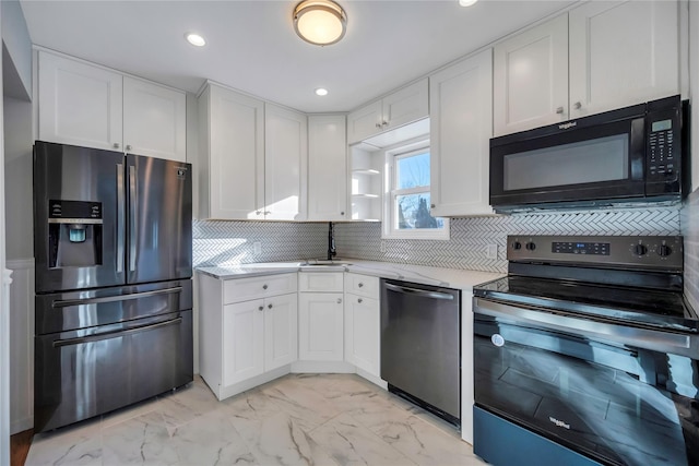 kitchen featuring sink, white cabinets, stainless steel appliances, and tasteful backsplash